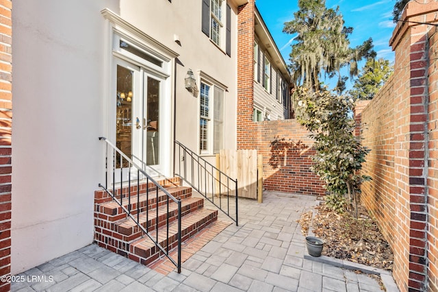 exterior space with entry steps, french doors, and fence