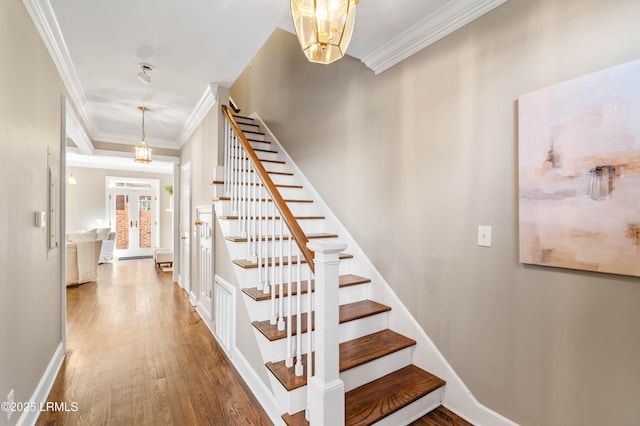 stairs with french doors, ornamental molding, wood finished floors, and baseboards