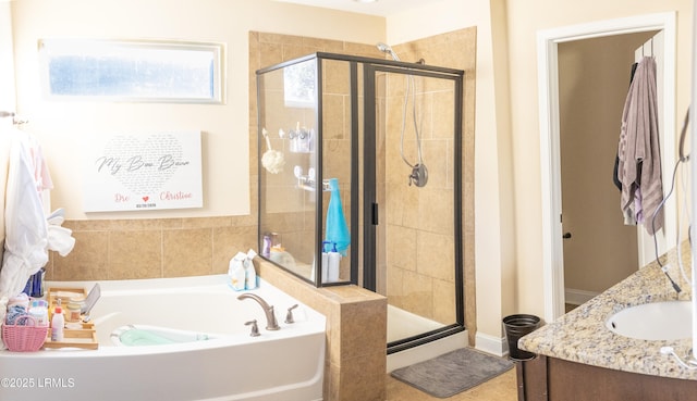 bathroom featuring vanity and shower with separate bathtub