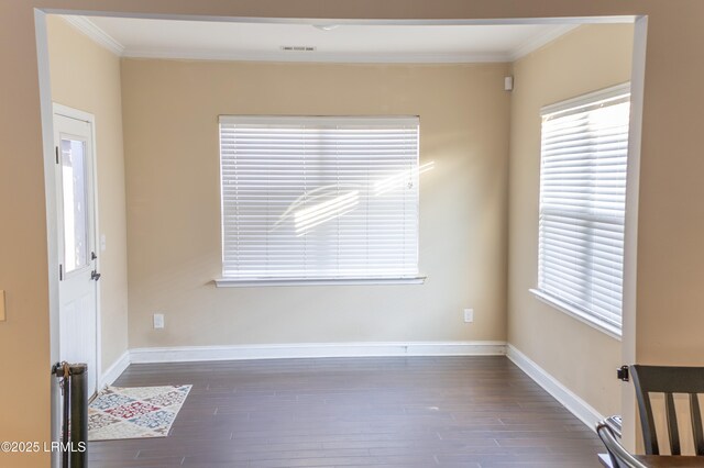 unfurnished room with crown molding and dark wood-type flooring