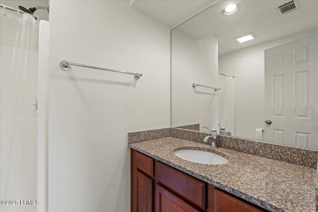 bathroom featuring visible vents, recessed lighting, and vanity