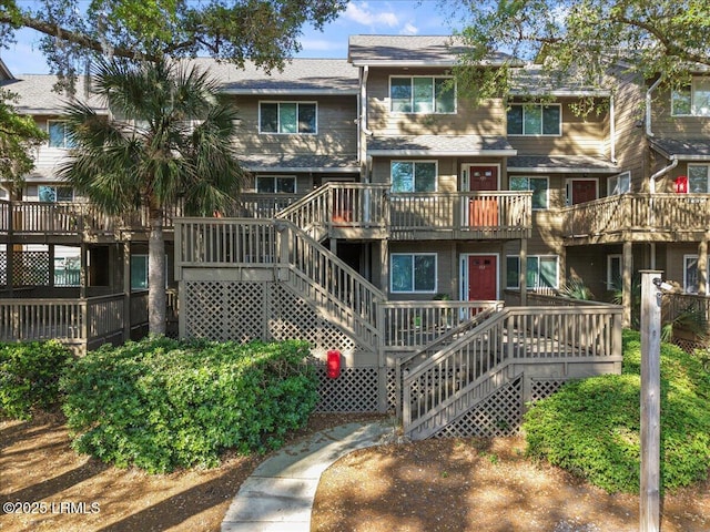 multi unit property with a wooden deck and stairs