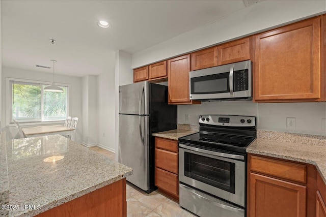 kitchen with hanging light fixtures, brown cabinetry, stainless steel appliances, light stone countertops, and recessed lighting