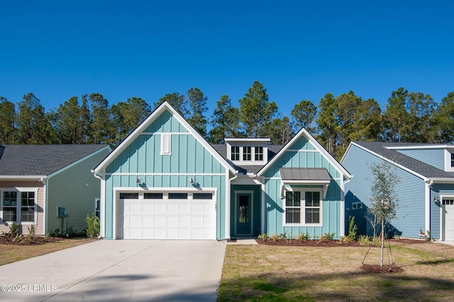 view of front of property featuring board and batten siding, a front yard, a standing seam roof, and a garage