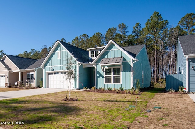 view of front facade with board and batten siding, a standing seam roof, a garage, driveway, and a front lawn