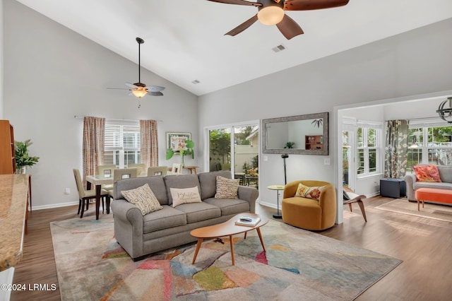 living room with ceiling fan, high vaulted ceiling, and hardwood / wood-style floors