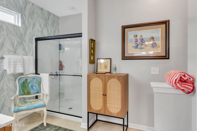 bathroom with a shower with door and tile patterned flooring