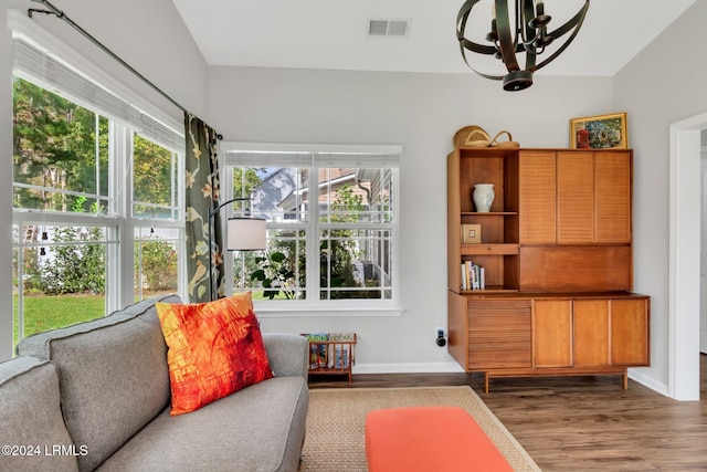 sitting room with dark hardwood / wood-style flooring and an inviting chandelier