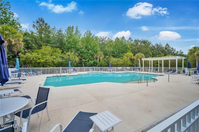 view of swimming pool with a pergola and a patio