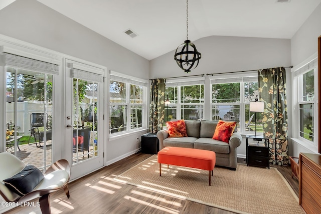 sunroom / solarium featuring vaulted ceiling