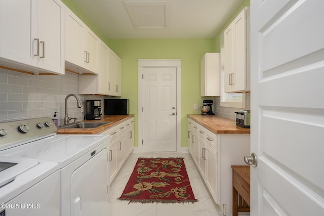 laundry room featuring cabinet space, washer and clothes dryer, and a sink