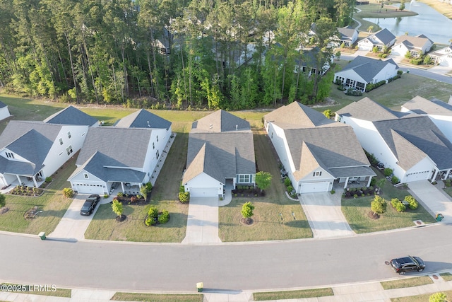 birds eye view of property with a water view and a residential view