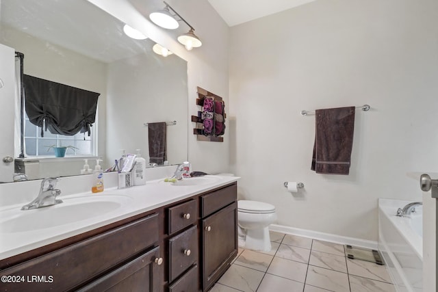 bathroom with vanity, a washtub, and toilet