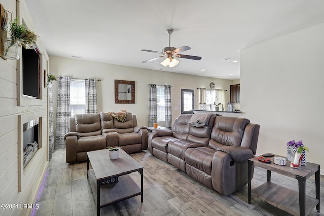 living room featuring plenty of natural light, light hardwood / wood-style floors, and ceiling fan