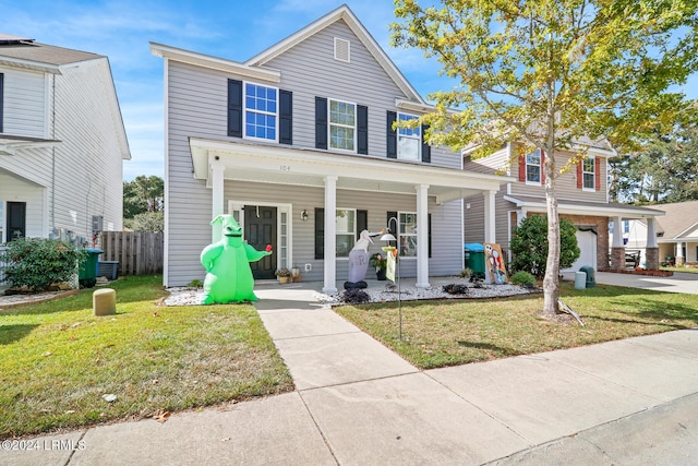 view of front of home with a porch and a front yard