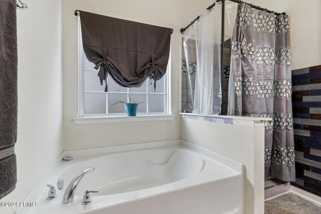 bathroom featuring separate shower and tub