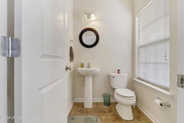 bathroom featuring toilet and tile patterned flooring