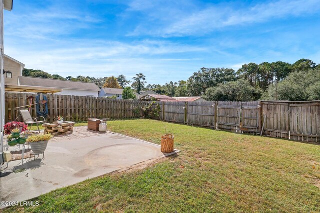 view of yard with a fire pit and a patio