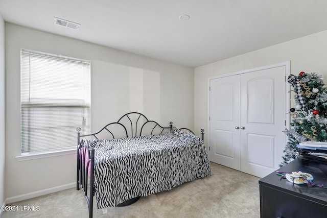 carpeted bedroom with a closet