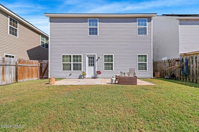 back of house with a yard, outdoor lounge area, and a patio