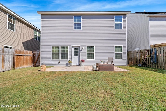 back of house with a yard, outdoor lounge area, and a patio