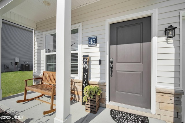 entrance to property with central AC and a porch