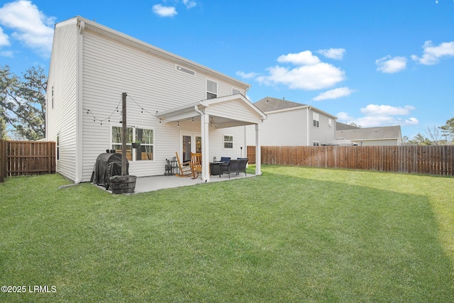 rear view of property featuring ceiling fan, a fenced backyard, a yard, and a patio