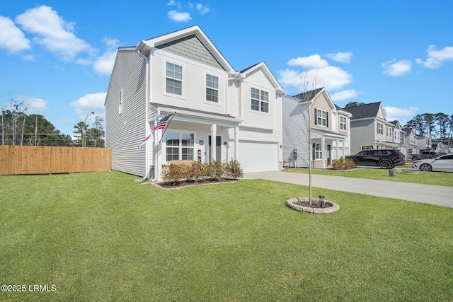 traditional-style home with driveway, a garage, a residential view, fence, and a front lawn