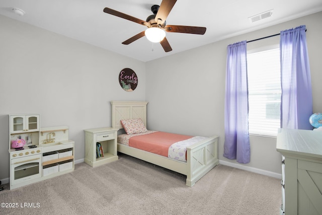 carpeted bedroom featuring baseboards, visible vents, and ceiling fan