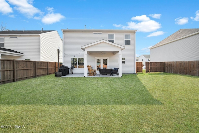 back of property featuring a yard, a patio area, a fenced backyard, and a ceiling fan