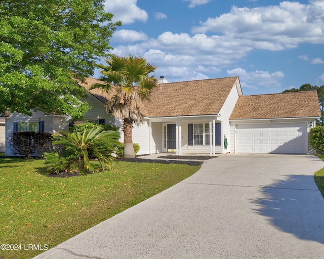 view of front of house with a garage and a front yard