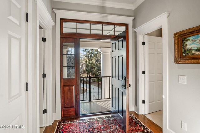 doorway featuring hardwood / wood-style flooring and ornamental molding