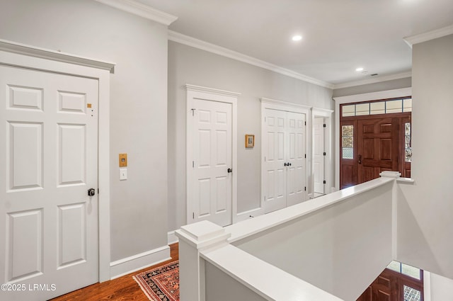 entryway with hardwood / wood-style flooring and crown molding