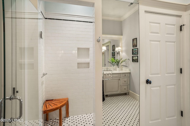 bathroom with ornamental molding, a shower with shower door, tile patterned flooring, and vanity