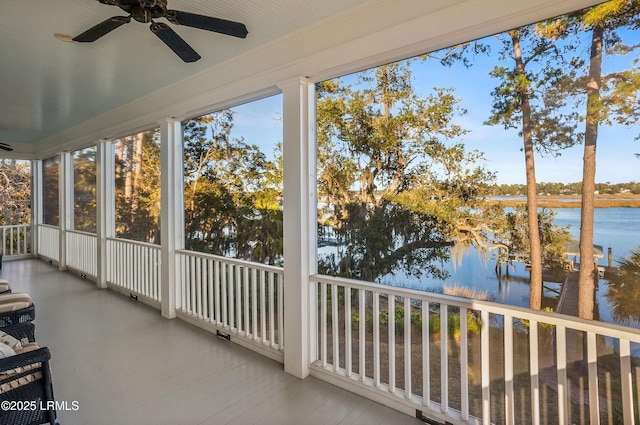 unfurnished sunroom featuring a water view and ceiling fan