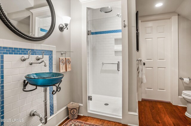 bathroom featuring sink, hardwood / wood-style flooring, toilet, and walk in shower