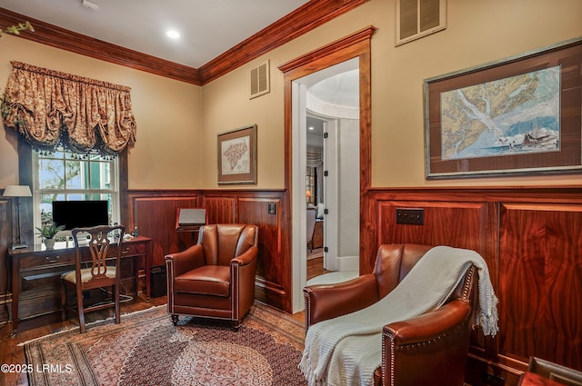 sitting room featuring crown molding and wood-type flooring