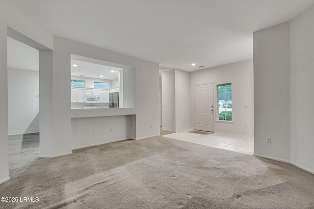 unfurnished living room with light carpet