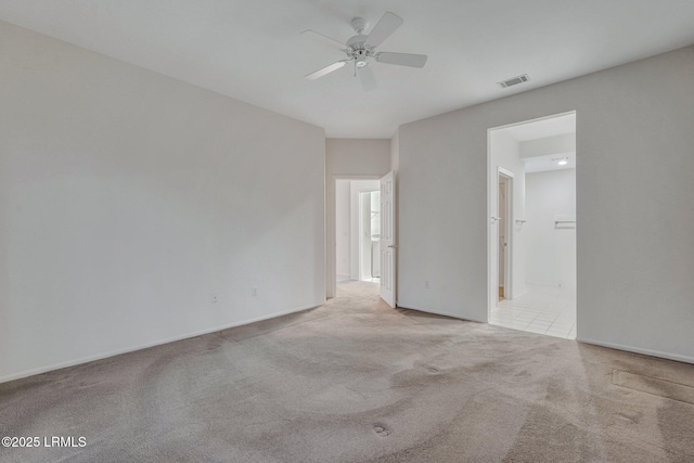 carpeted empty room featuring ceiling fan