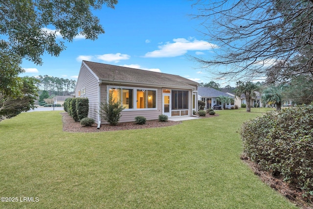 rear view of property featuring a yard