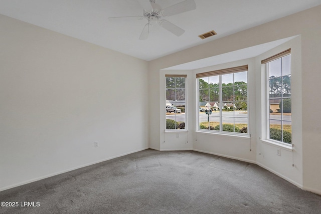 spare room featuring ceiling fan and carpet floors