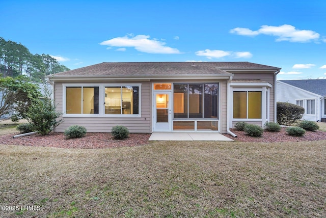 rear view of property with a patio area and a lawn