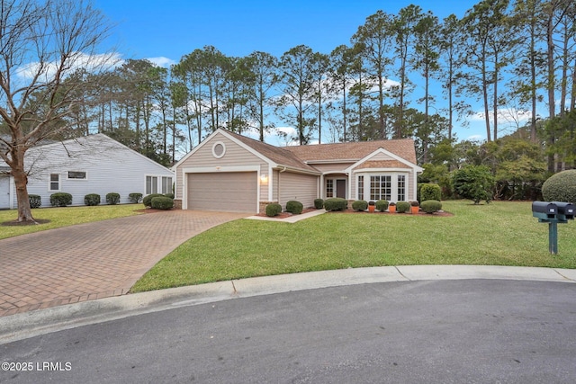 ranch-style house featuring a garage and a front lawn