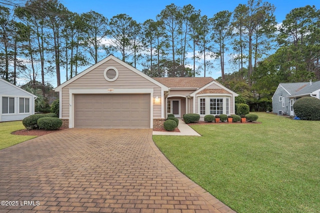 single story home with a garage and a front yard