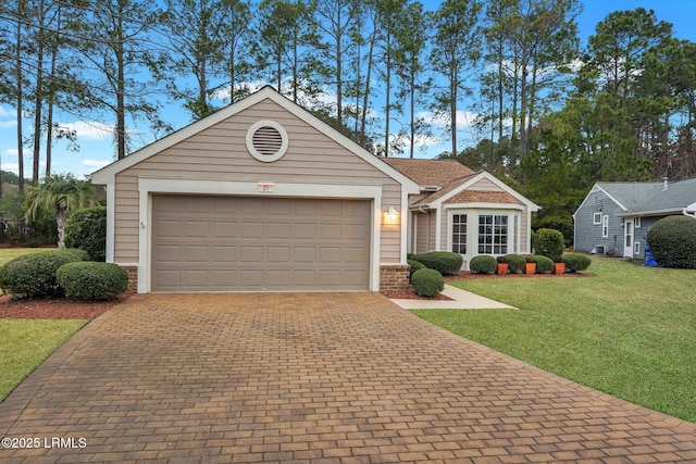 ranch-style house with a garage and a front lawn