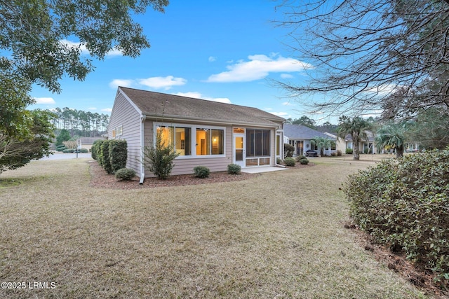 back of house with a lawn