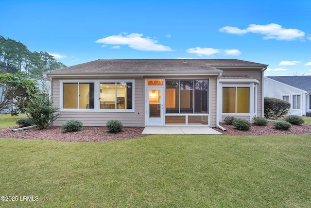 rear view of house featuring a yard and a patio area