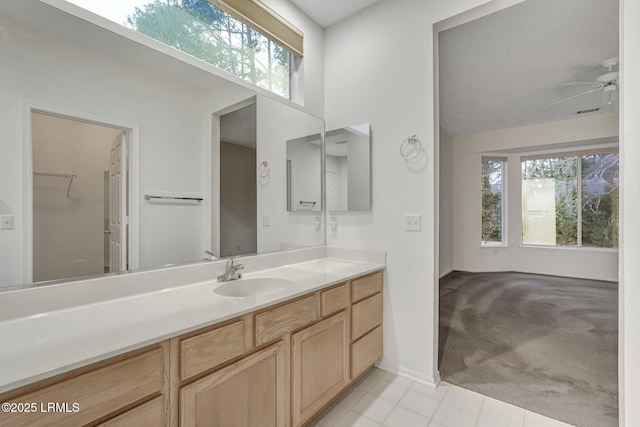 bathroom featuring vanity, vaulted ceiling, tile patterned floors, and ceiling fan