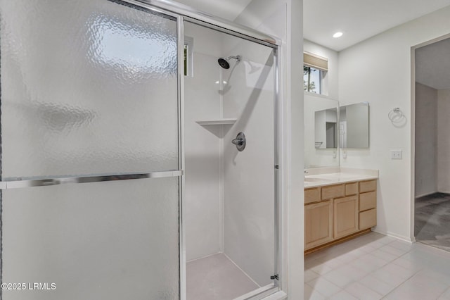 bathroom featuring walk in shower, tile patterned floors, and vanity