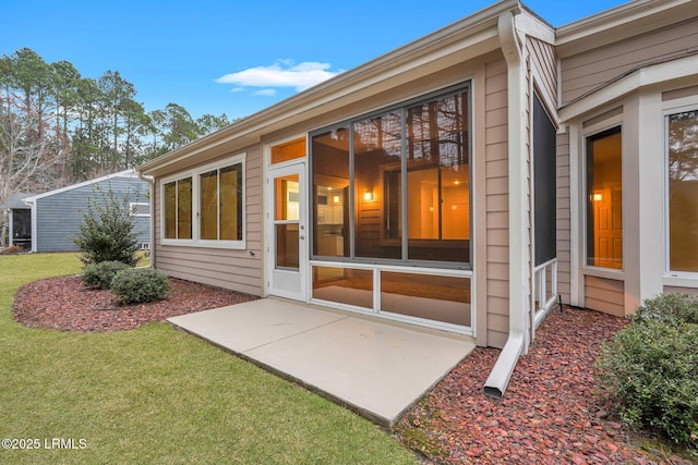 back of property with a lawn and a patio area